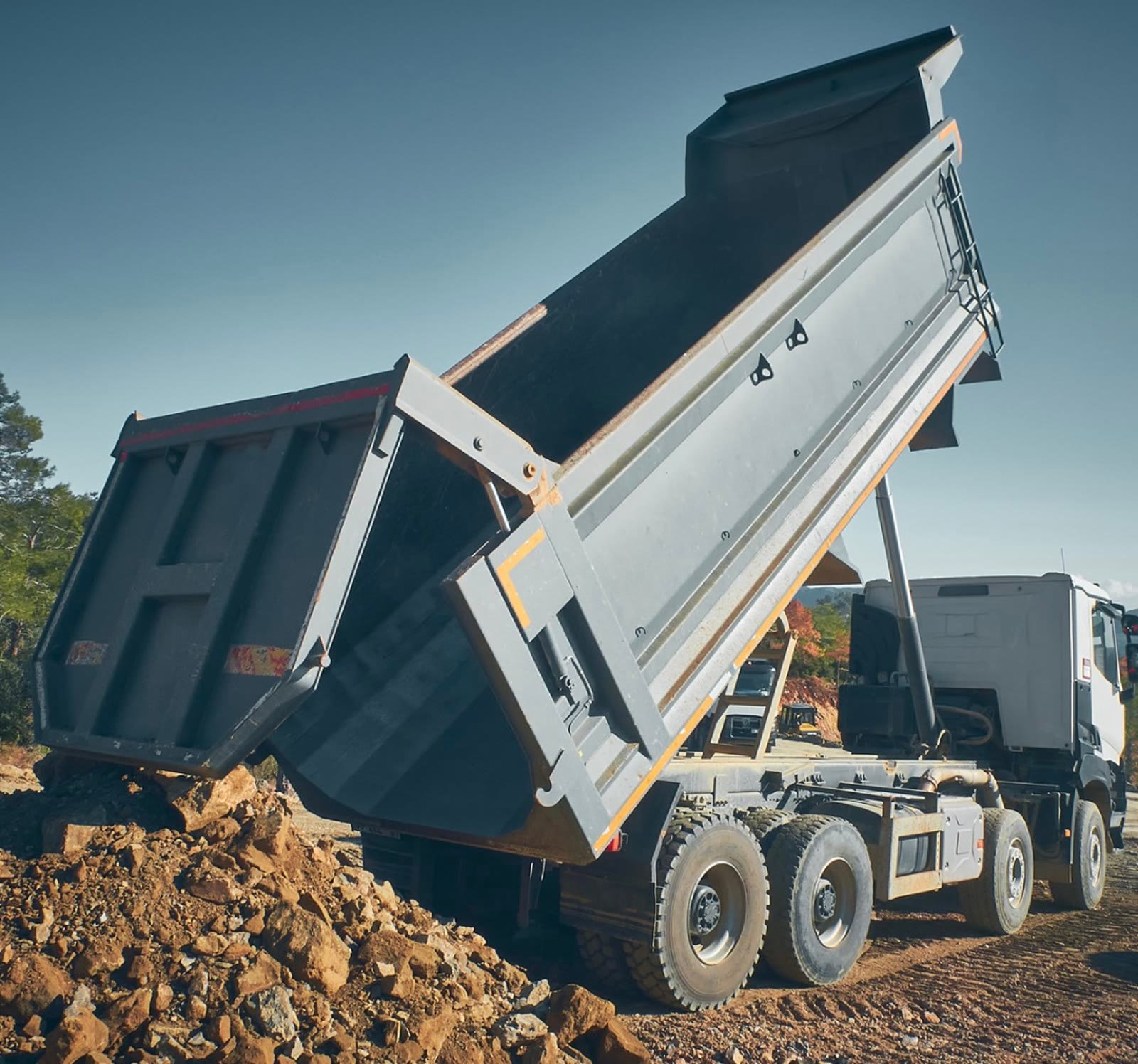 Dump truck offloading material on site